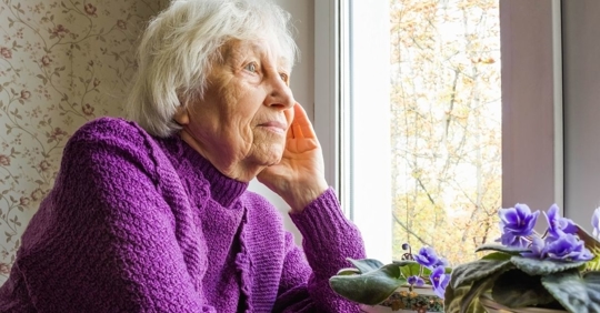 sad woman looking out the window